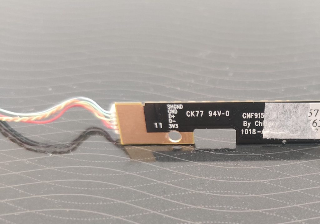 Image of a laptop webcam module with the wire labels printed on a silkscreen
